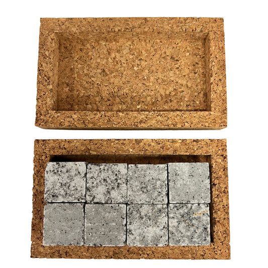 Open cork box displaying eight grey whiskey stones