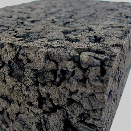 Dark, low density cork carving block angled to show texture and thickness