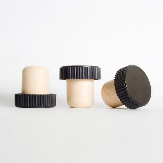 Various angles of black plastic ribbed capped stoppers with synthetic cork stems