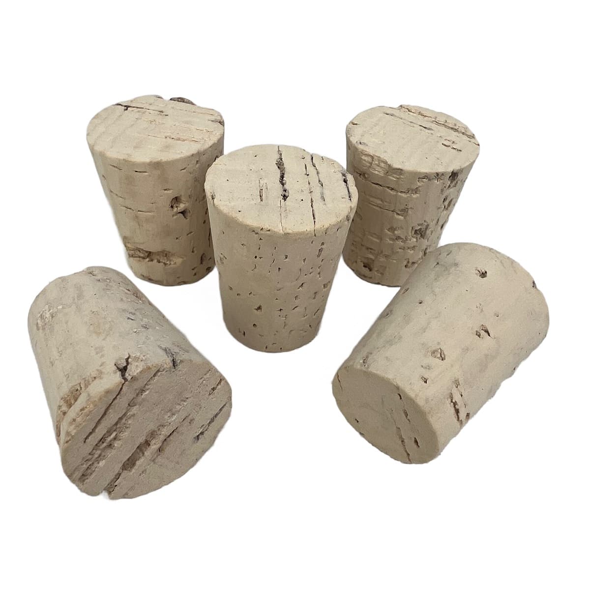 Five natural tapered cork stoppers on a white background