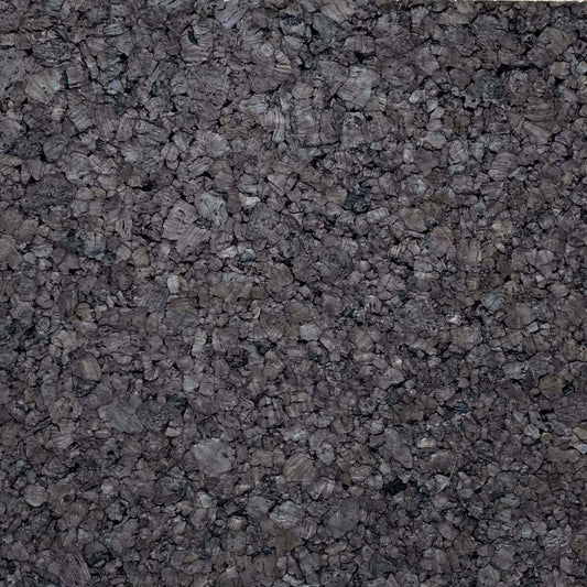 Close-up of dark cork insulation tile surface showing dark brown color and large, chunky cork grain texture
