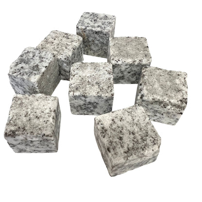 Eight whiskey stones laid out to show their cube shape and marbled texture