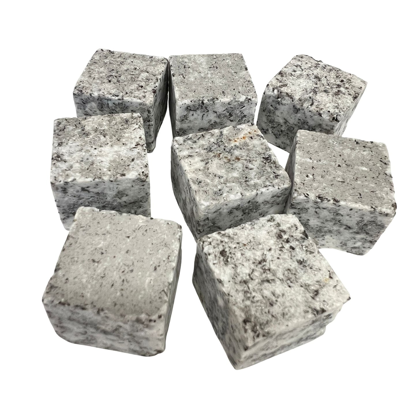 Eight whiskey stones arranged to show their cube shape and marbled grey tones