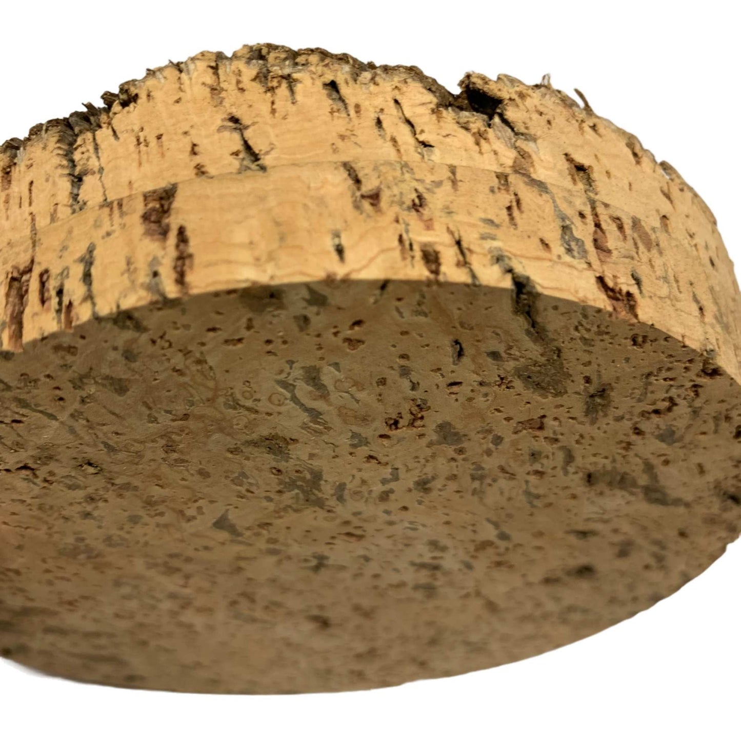 Close up of BT10 rough top natural cork stoppers, shows textured top and smooth sides and bottom