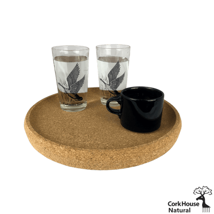 The natural cork tray with raised lip holds two clear glasses of water and a black coffee mug.