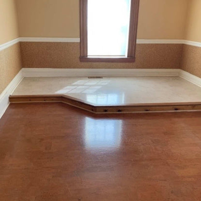 Room with harmony brown flooring with a white accent floor on a slightly raised platform.