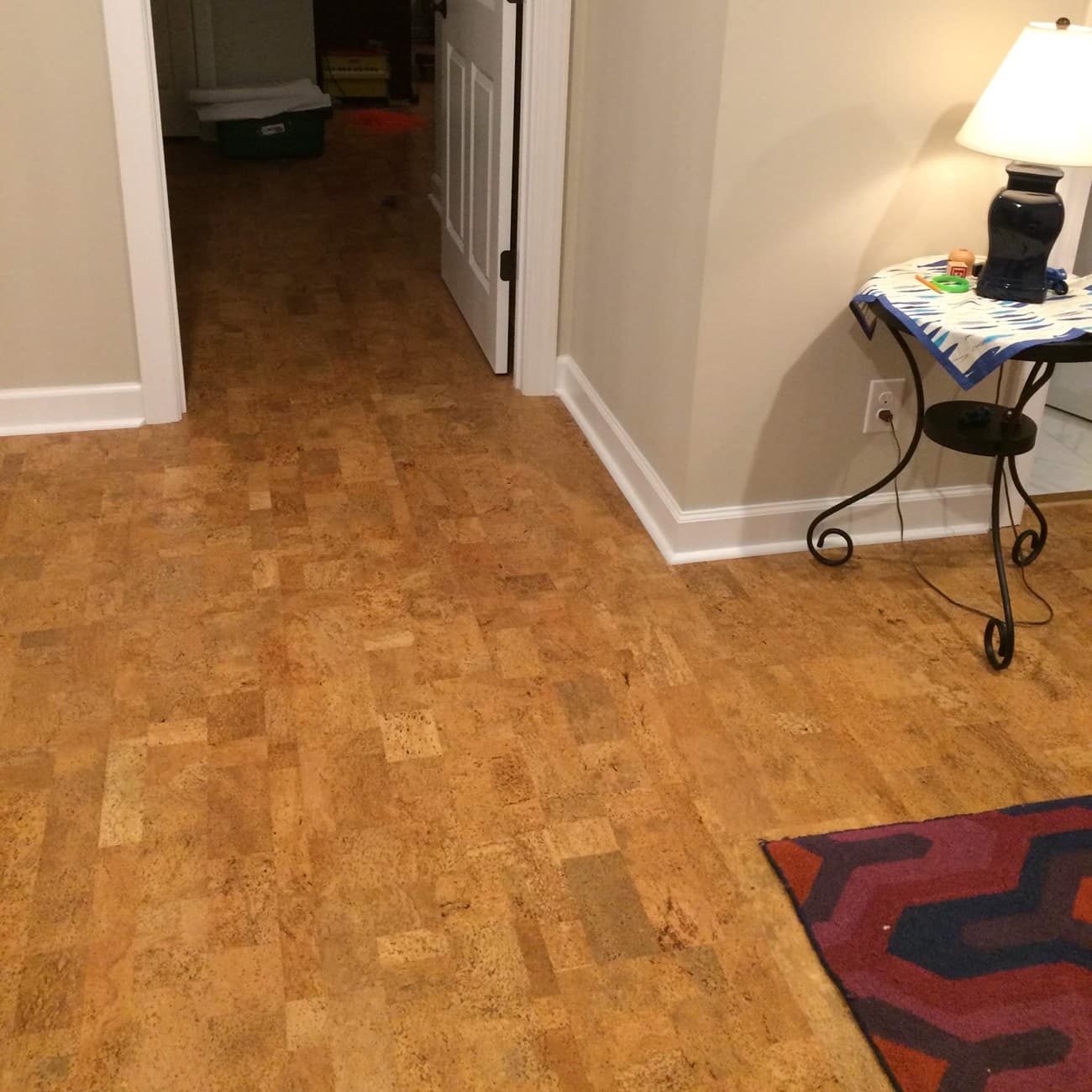 Harmony cork floor with a rug and small table in a room.