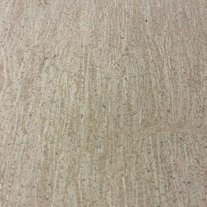 Close-up of bamboo-pattern cork floor tile with beige striations and dark brown flecks