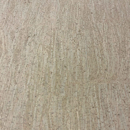 Close-up of bamboo-pattern cork floor tile with beige striations and dark brown flecks