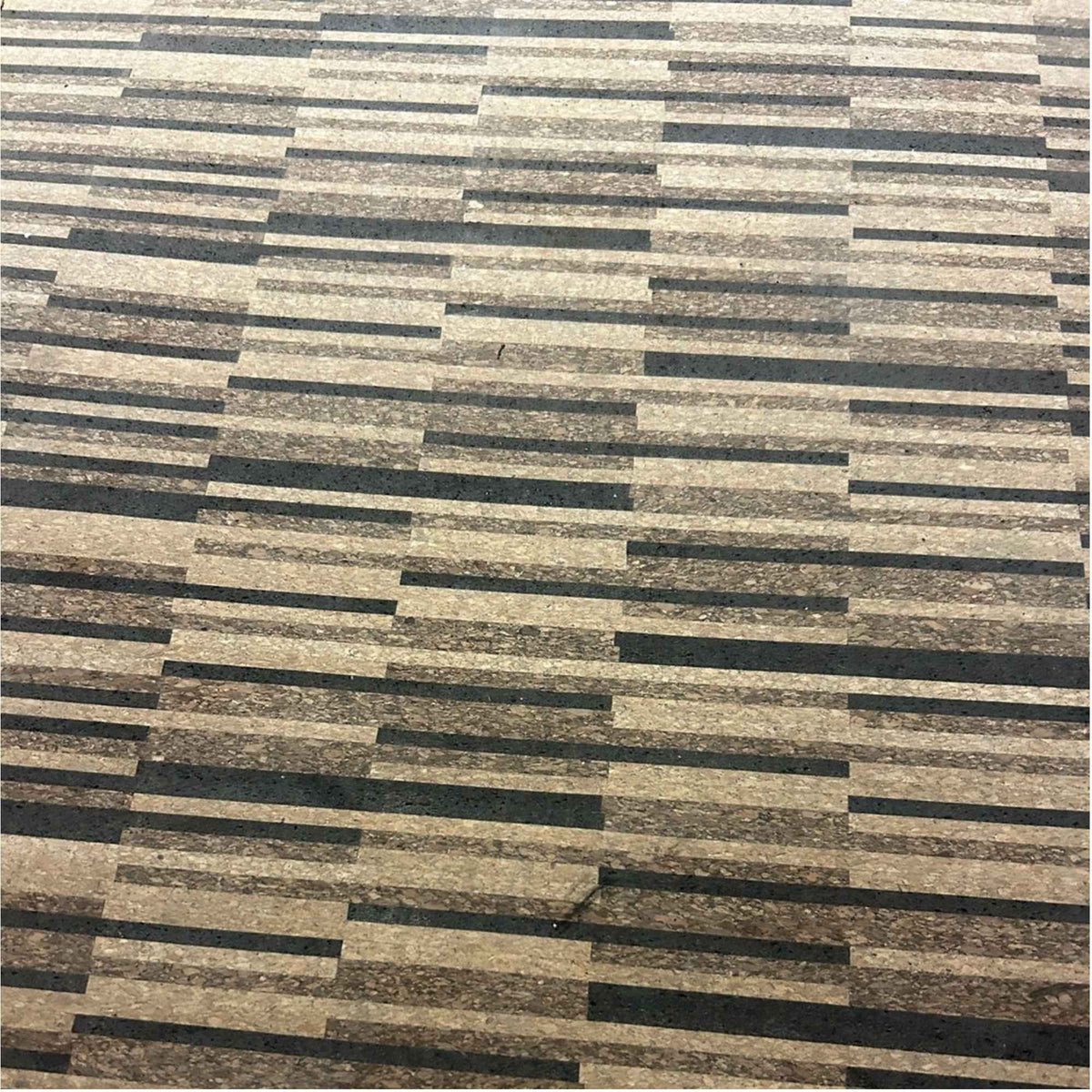 Close-up of the striped pattern and coloring on a Rio XL unfinished cork floor tile