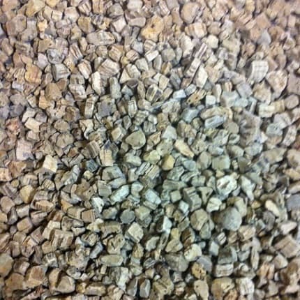 Close-up of small pieces of cork grain with a focus on texture and color variation.