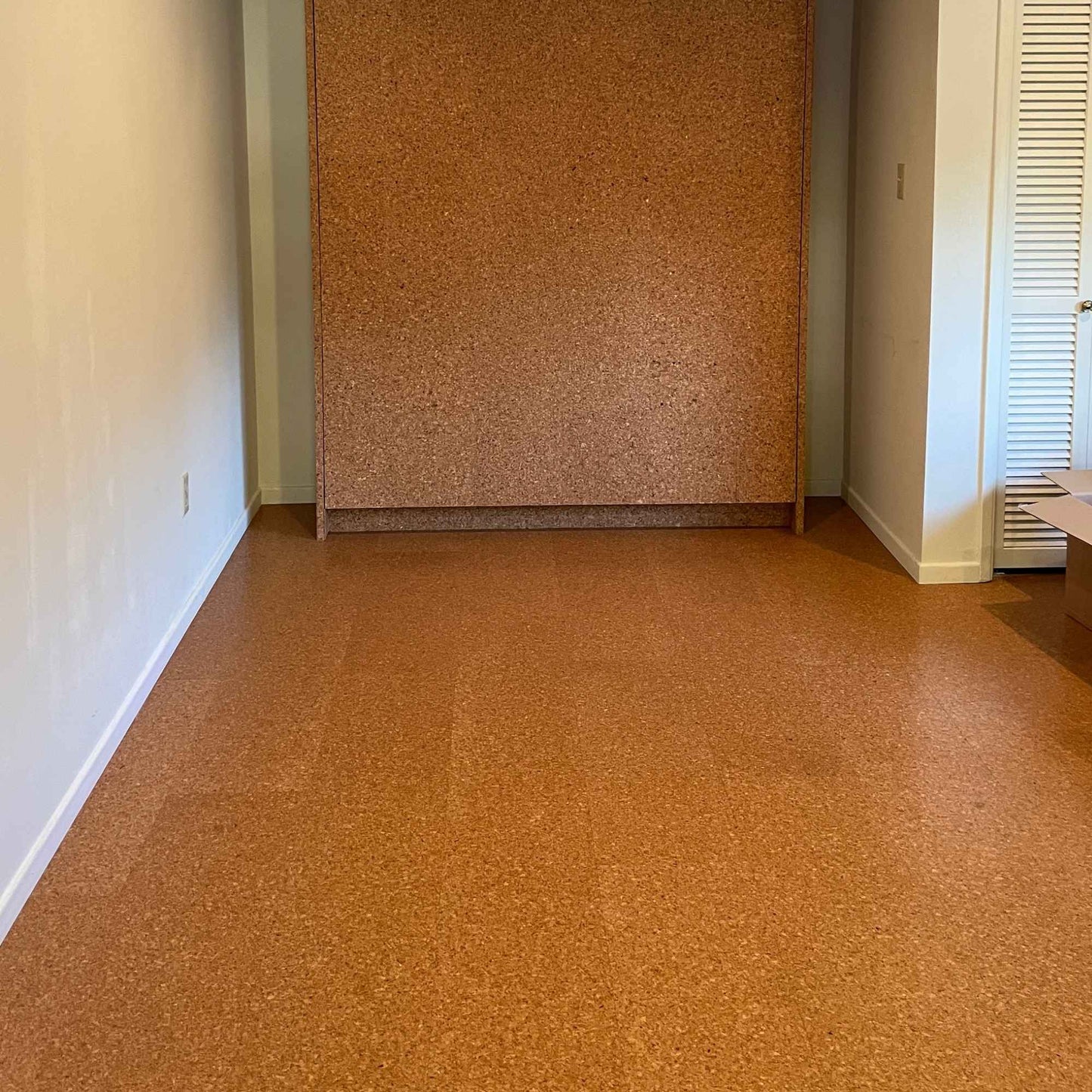 Pebble floating cork flooring installed in a family room. The room also has a cork wall.