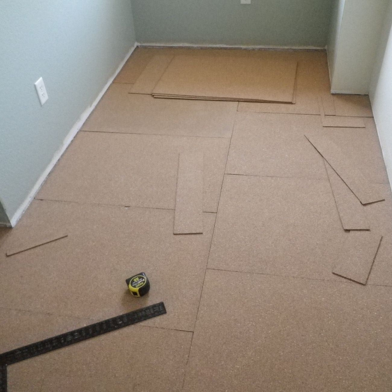 QuietCork underlayment sheets cut and sized to fit a room