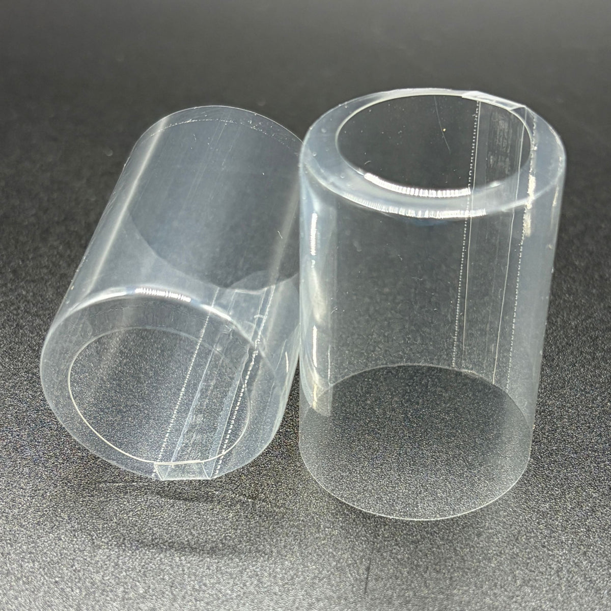Shrink caps, clear with open top and vertical double perforation.