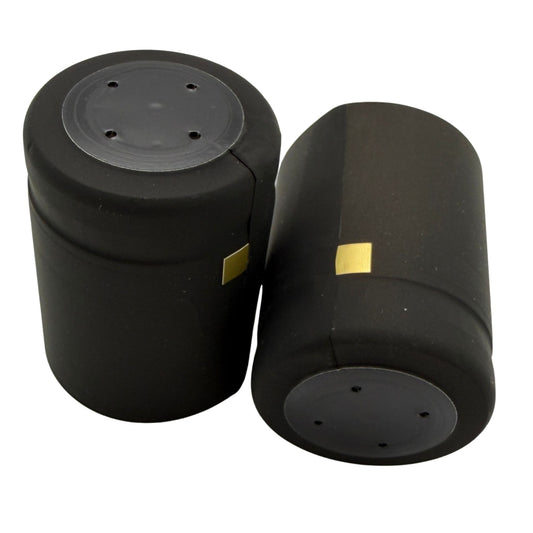 Matte black closed cap PVC shrink cap with closed cap and gold horizontal tear tab. Close-up. 