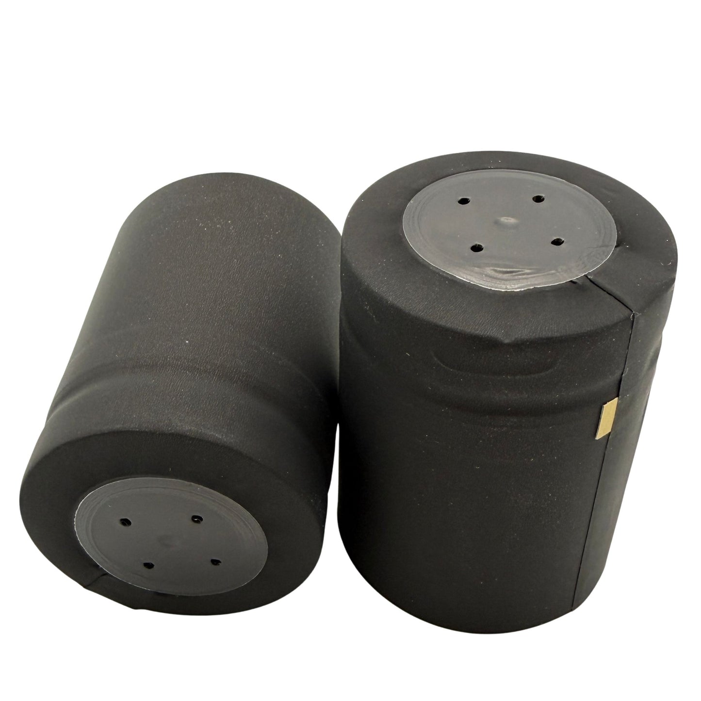 Two matte black closed cap PVC shrink cap with gold horizontal tear tab, close-up to see top and sides.
