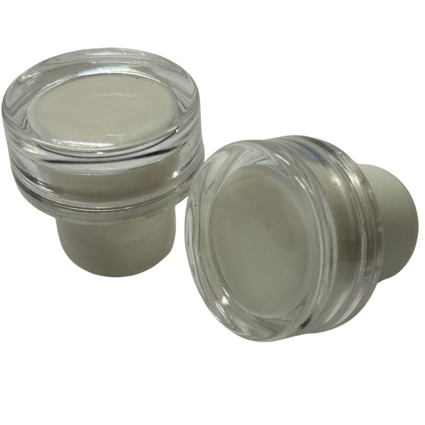 2 clear acrylic cap stoppers with white synthetic cork stems.