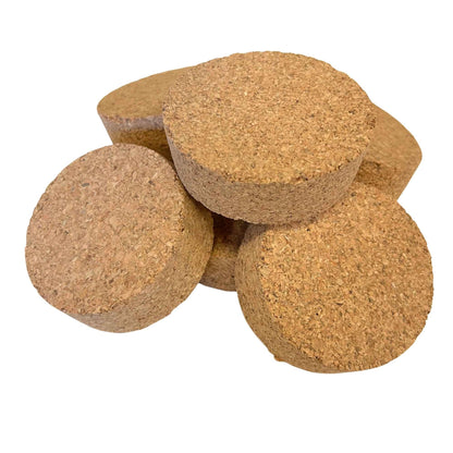 Pile of short length tapered cork stoppers in SL46 showing agglomerate texture and conical shape