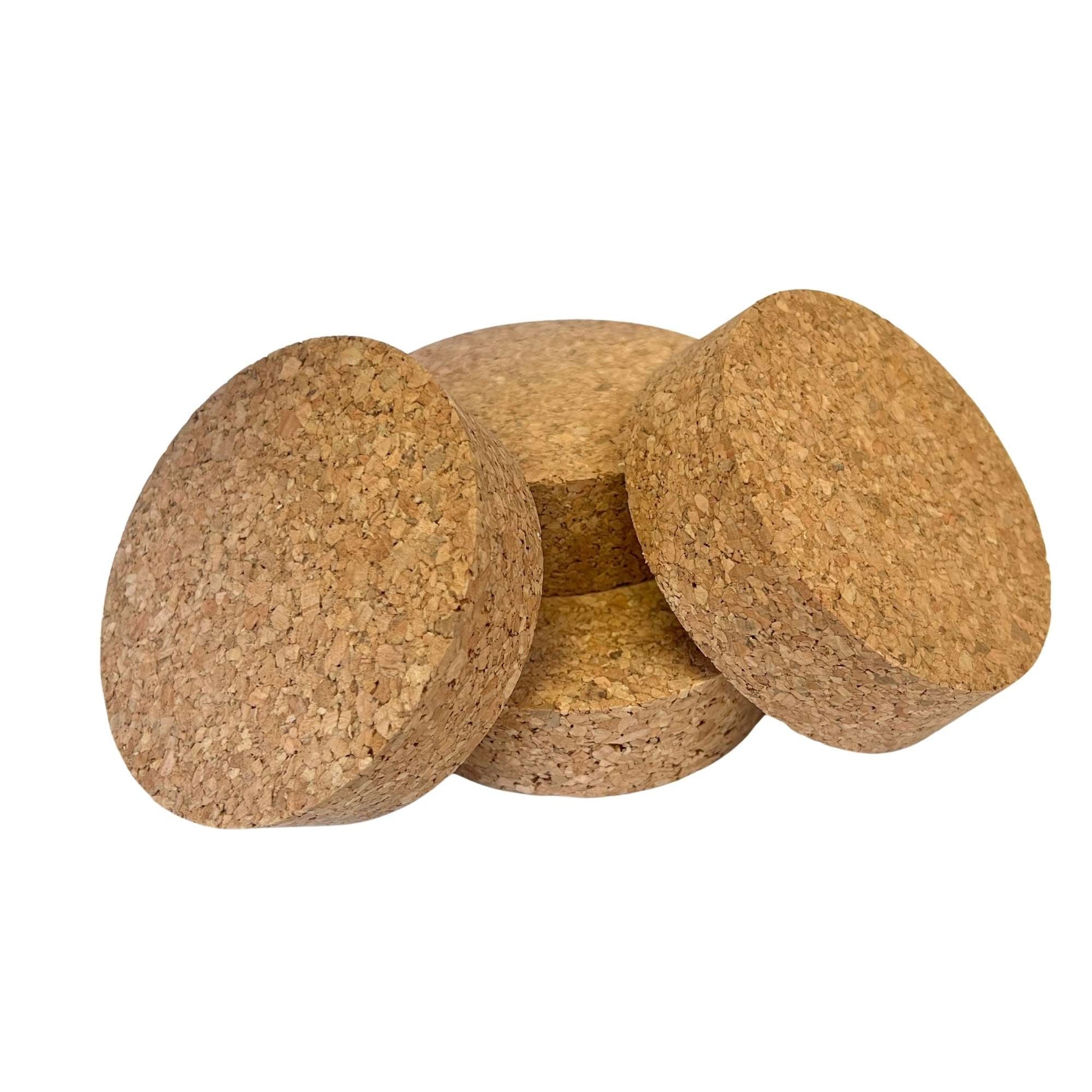 Pile of short length tapered cork stoppers in SL52 showing agglomerate texture and conical shape