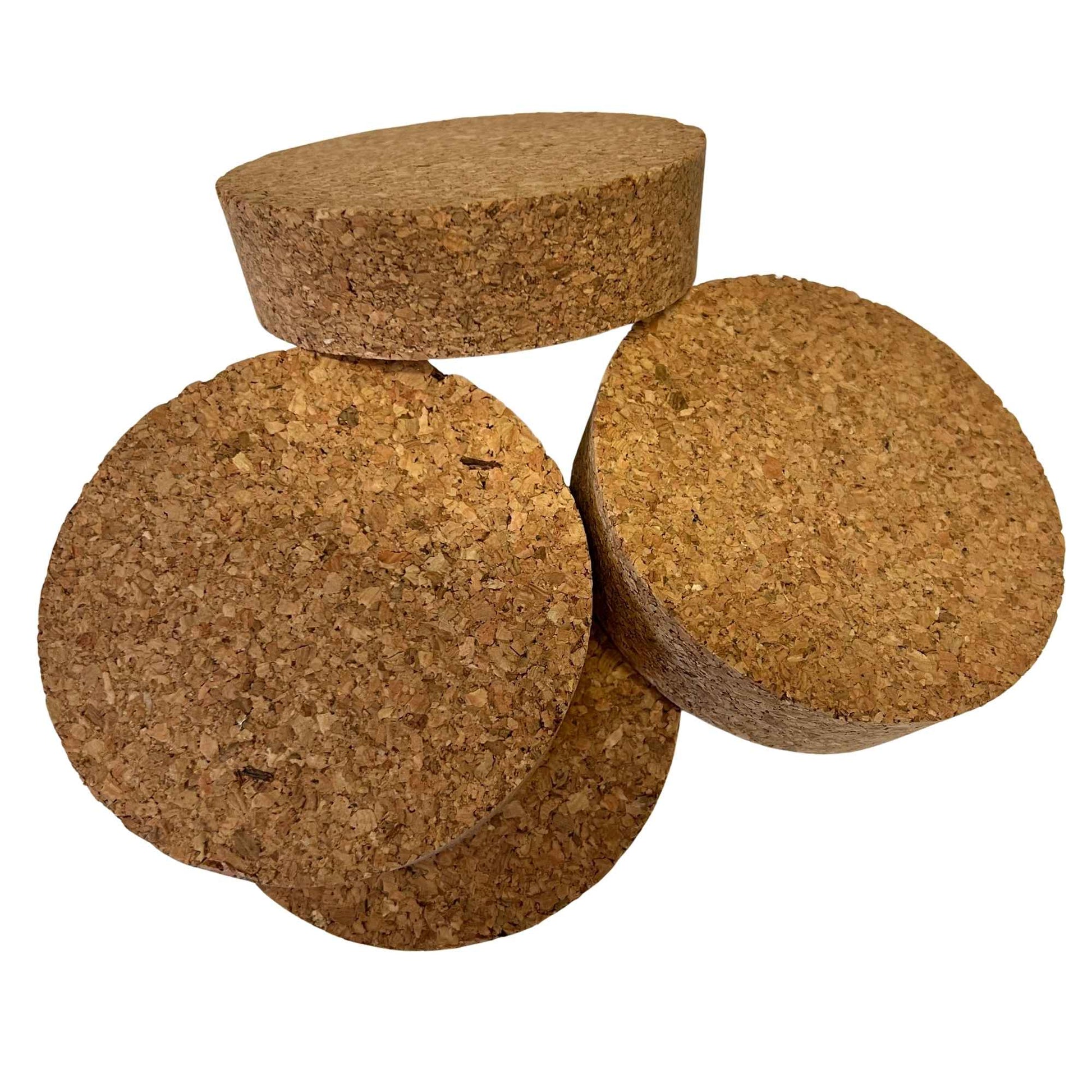 Pile of large short length tapered cork bungs in SL54 showing agglomerate texture and conical shape
