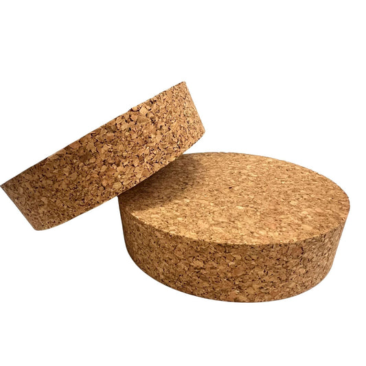 Two short length tapered cork stoppers in SL58 showing agglomerate texture and conical shape
